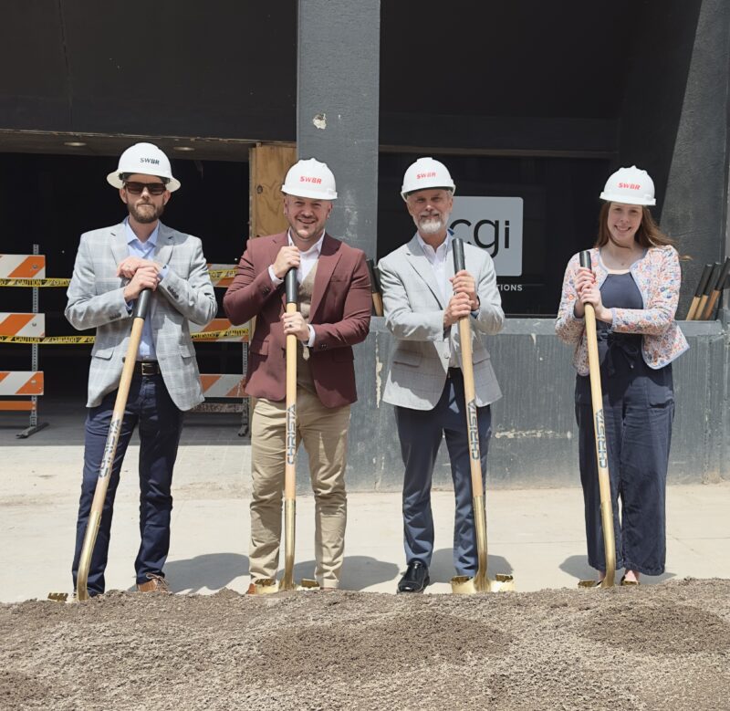 Four people with shovels and hard hats standing at the groundbreaking for Gateway Apartments in Rochester, NY.